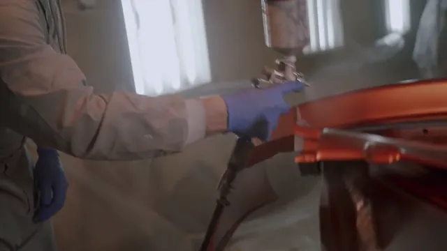 Automotive spray painting in a refinishing booth